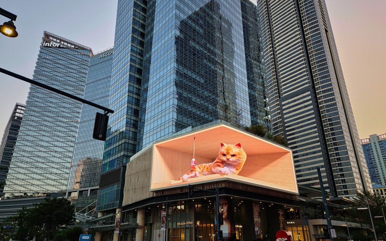Building-mounted advertising display in a commercial district.