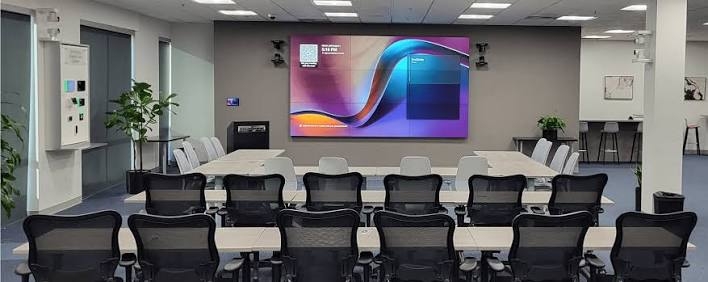 Training room with table seating facing a presentation display.