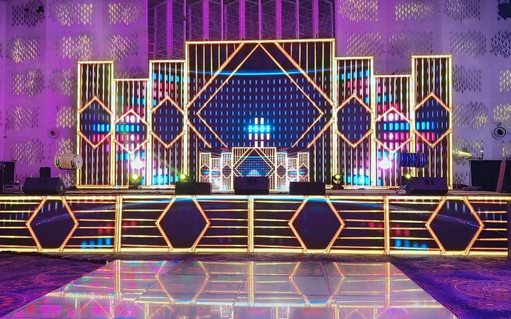 Creative stage with curved LED surfaces and mapped content.